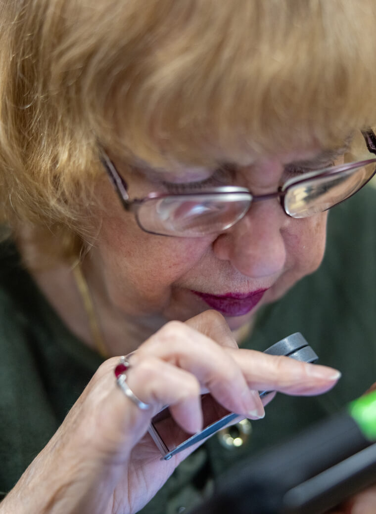 Woman looking through magnifying glass