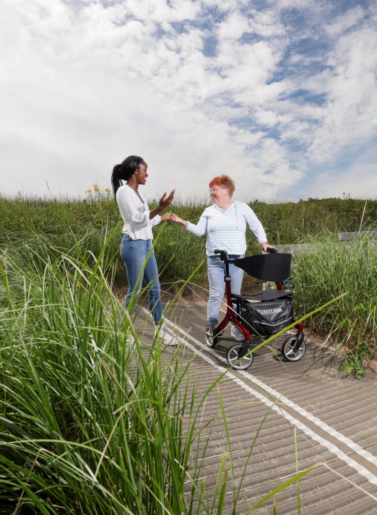 Two people talking near a field