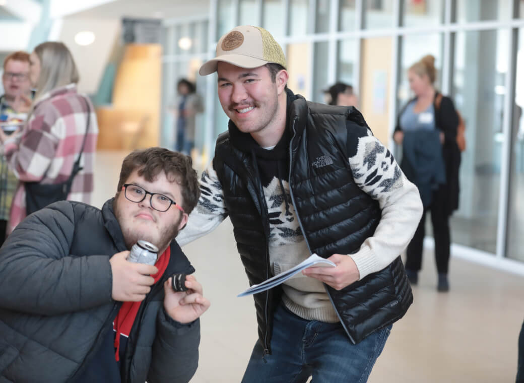 Two people leaning in smiling