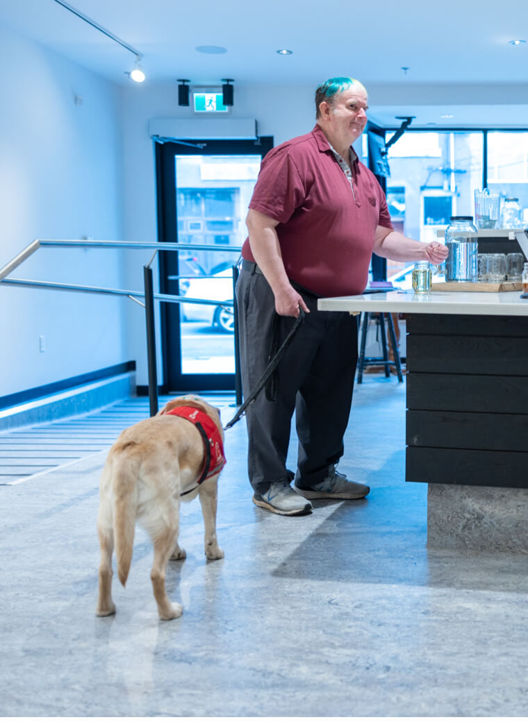Person at counter with dog on leash